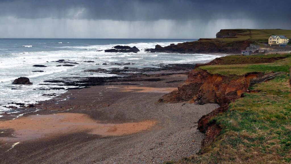 Dramatic cliffs and golden beach along the Cornwall coast near Bude – one of the scenic highlights featured in Bespoke England Tours' custom coastal getaways.