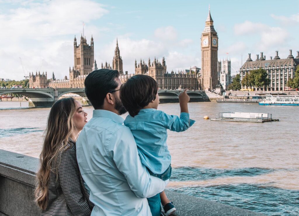 Family viewing Big Ben beside the Thames